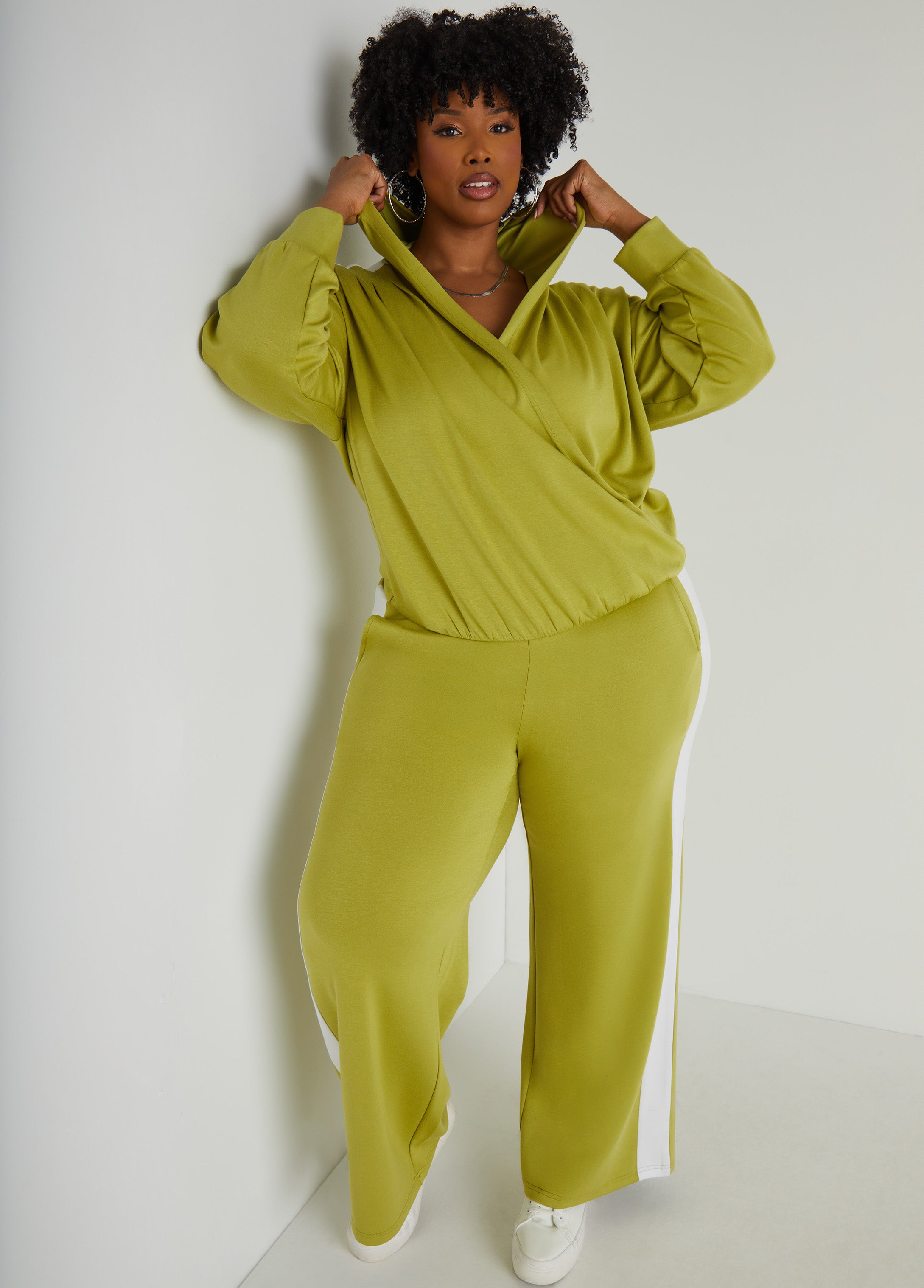 High-rise stretch-knit straight-leg track pants with two slit pockets at sides and striped trims. Pull-on style. Inseam: 31in. Can be worn as a two-piece set with matching top. Top sold separately.