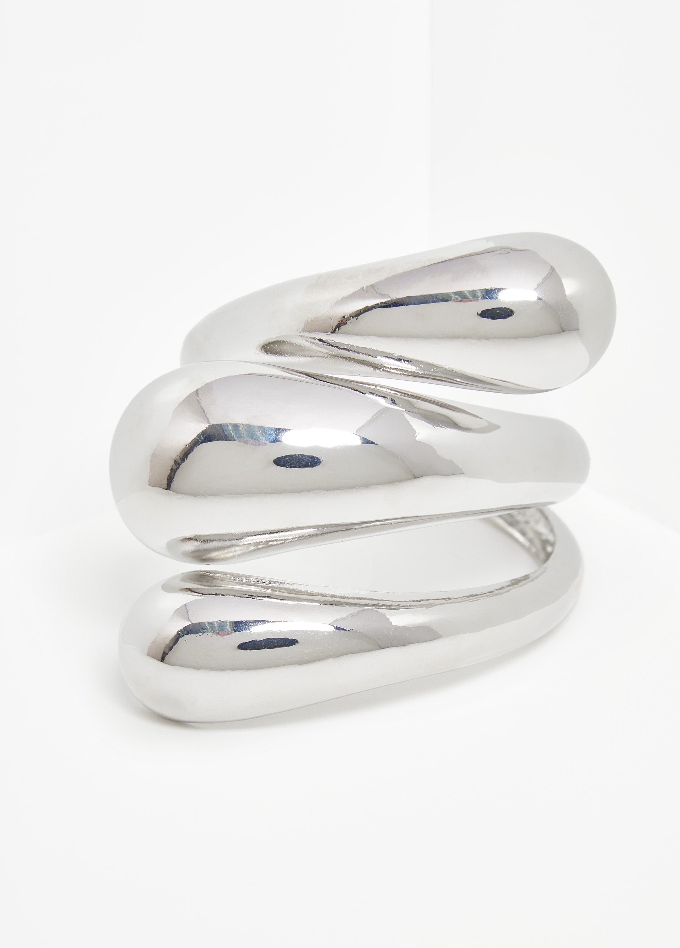 Swirl cuff in silver-tone metal.