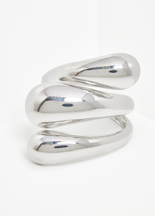 Swirl cuff in silver-tone metal.